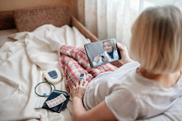 woman in bed looking at screen